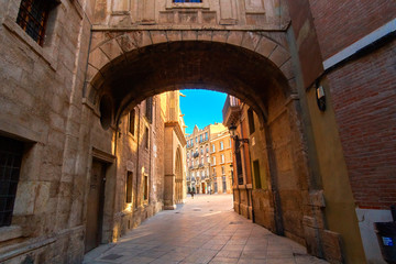 Fototapeta na wymiar Valencia Spain Narrow Street with Arch Bridge