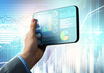 Media technology concept presented by businessman holding tablet with graphs and diagrams
