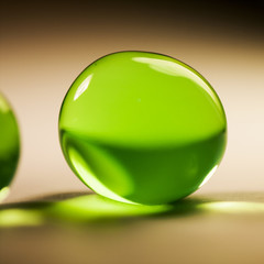 Abstract composition with beautiful, green, round jelly balls, paper surface and paper background
