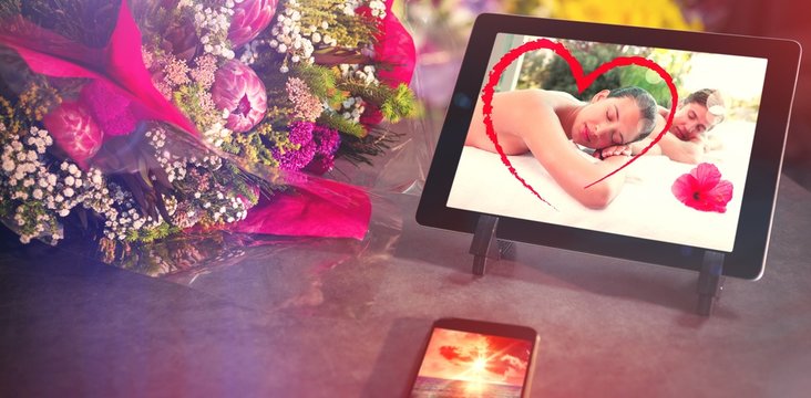 Composite image of technology with flower bouquet