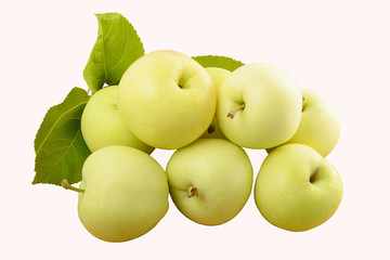 several green apples with leaves on a white background
