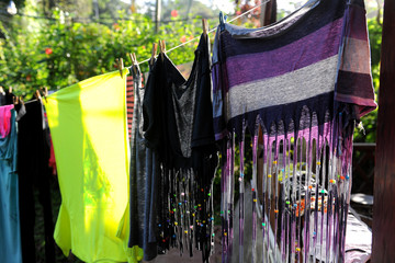 Brightly colored clothes hanging on a line to dry
