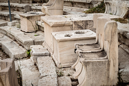 Stone chairs on amphitheater for public performances of music and poetry, below on the Acropolis, Athens, Greece