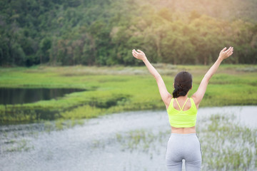 Relaxed woman breathing fresh air raising arms.