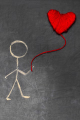 Fototapeta na wymiar cartoon man with chalk on blackboard with red heart