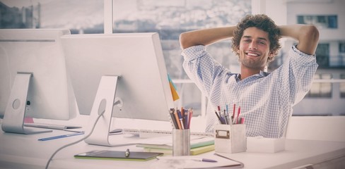 Relaxed casual business man with computer in bright office