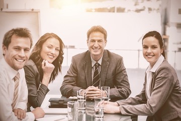 Portrait of a positive team sitting at a table