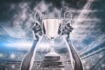Tuinposter Composite image of cropped hand of athlete holding trophy 3d © vectorfusionart