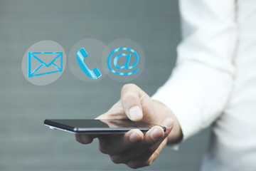 Man using a mobile phone while emitting a clouds of contact icon