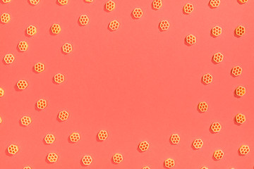 Frame from wheat pasta on red background