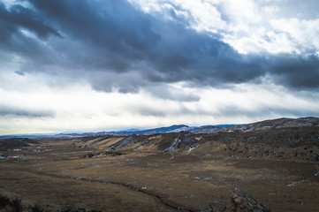 Dark clouds over Colorado mountain valley.