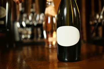 Wine bottle on wooden table at liquor store