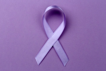 Lavender ribbon on color background. Cancer and epilepsy concept