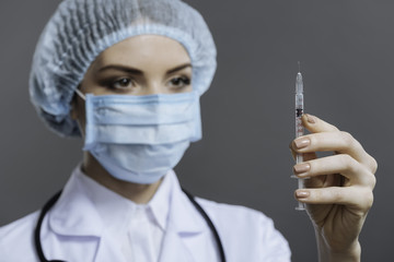 Female doctor preparing to make the injection