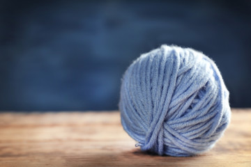 Ball of  knitting yarn on wooden table