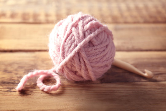 Ball of  knitting yarn on wooden table