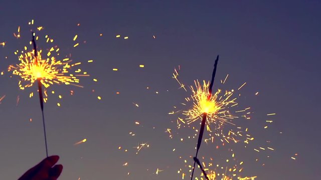 Young couple with sparklers celebrating, dancing and smiling. Happy people. Slow motion 240 fps. Full HD 1080p