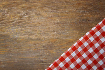 Red napkin on wooden table