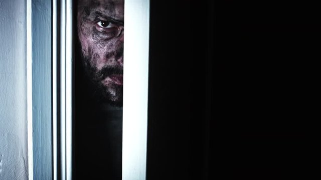 4K Thriller Dirty Man Eye Looking in Door Gap, zoom in slow