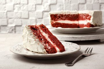 Slice of delicious red velvet cake on plate