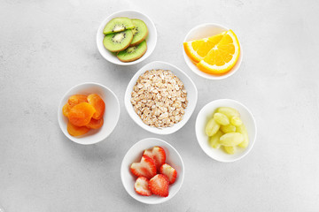 Set of diet products in saucers on grey textured background