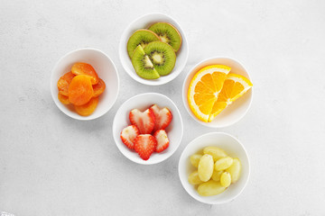 Set of diet products in saucers on grey textured background