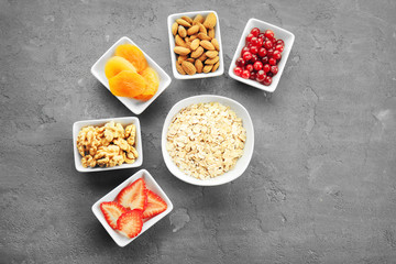 Set of diet products in saucers on grey textured background