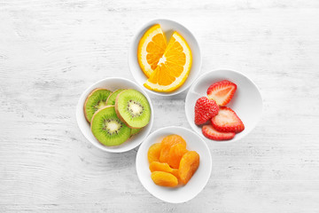 Set of diet products in saucers on wooden background