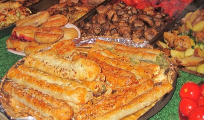 Puff pastry on a plate with baked mushrooms, fried potatoes, tom