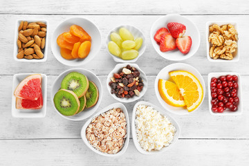 Set of diet products in saucers on wooden background