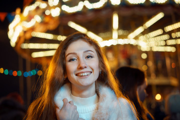 Fototapeta na wymiar red-haired girl on carousel in winter