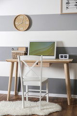 Workplace on striped wall background