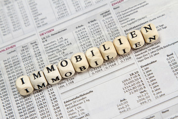 Fototapeta premium real estate word built with letter cubes