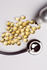 Fish oil capsules in bottle with stethoscope isolate on white background.Fish oil supplement capsule source of omega 3 ..