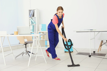 Professional cleaner cleaning floor in office