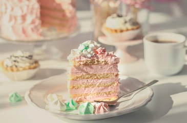 Plate with piece of tasty cake on table
