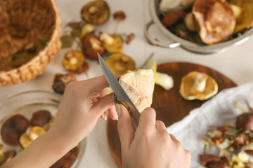 Woman preparing mushrooms at kitchen, closeup