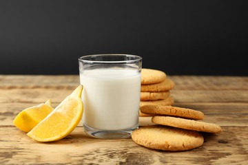 Lemon cookies with milk on table