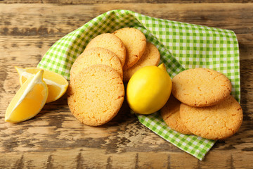 Lemon cookies and napkin on wooden background