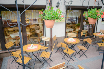 View of empty outdoor cafe chairs and table