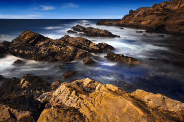 California Coast with ocean waves and rock formations.