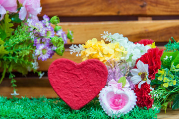 Heart-shaped box with colorful flowers in the season of love.