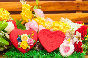 Heart-shaped box with colorful flowers in the season of love.