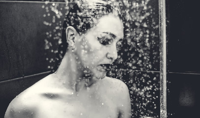 Beautiful sexy  young woman washing body in a shower