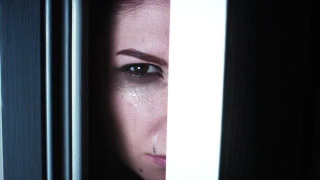 4K Thriller Woman Eye Looking in Door Gap Crying