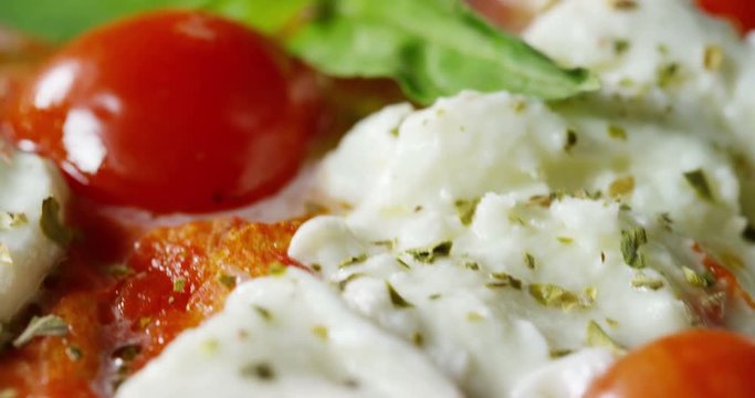 Super slow motion of a middle aged chef cutting mozzarella of bufala cheese for pizza on a restaurant kitchen table in 4k (close up)