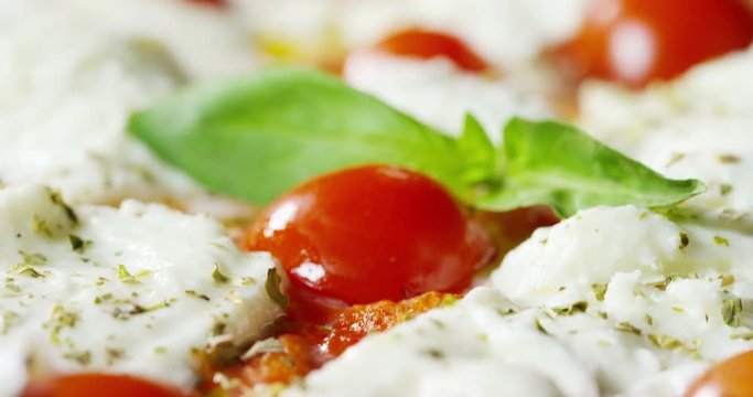 Super slow motion of a middle aged chef cutting mozzarella of bufala cheese for pizza on a restaurant kitchen table in 4k (close up)