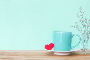 Coffee cup mug with red heart shape on wooden table , Romance 