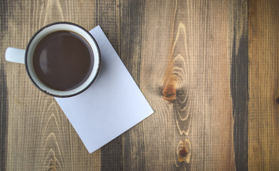 Black Coffee and Notepad on Wooden Background in Vintage Tone