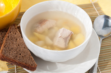 On the table, dinner: soup and black bread  